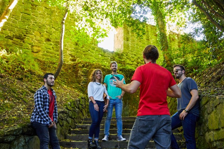 a group of people standing next to a tree